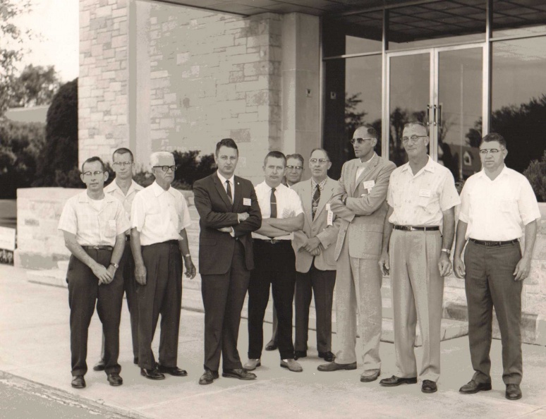 Woodward members pose outside the visitor's lobby.